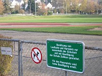  The sign at the edge of the running track says 