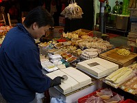  A street vendor slices big slabs of tofu