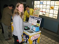  Lynn cleans her glasses for free at a ultrasound cleaning stand in a train station.