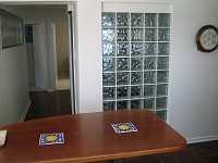  View from the kitchen, looking down the hallway on the left. Glass bricks on the right form the part of the shower wall.