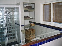  View from the bathroom door, looking into the mirror and across to the shower in the reflection.